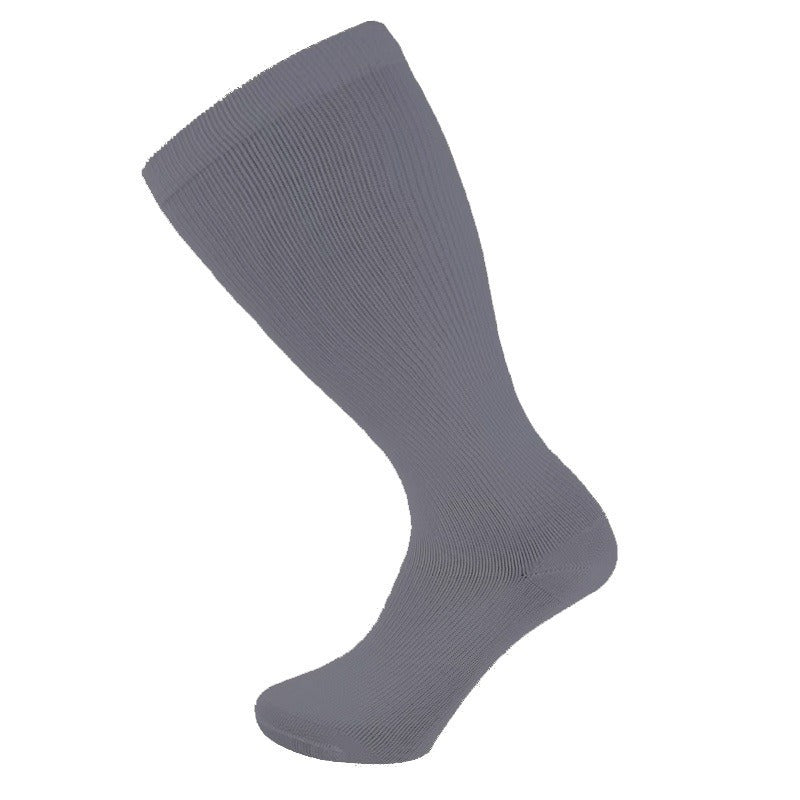 Pair of plus size knee high compression socks worn on the legs on a white background