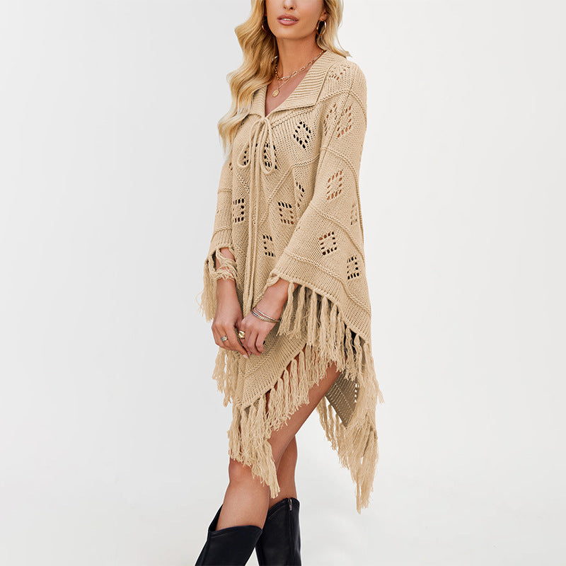 Knit cape poncho with collar tie and openwork stitch shown on a model with fringe hem