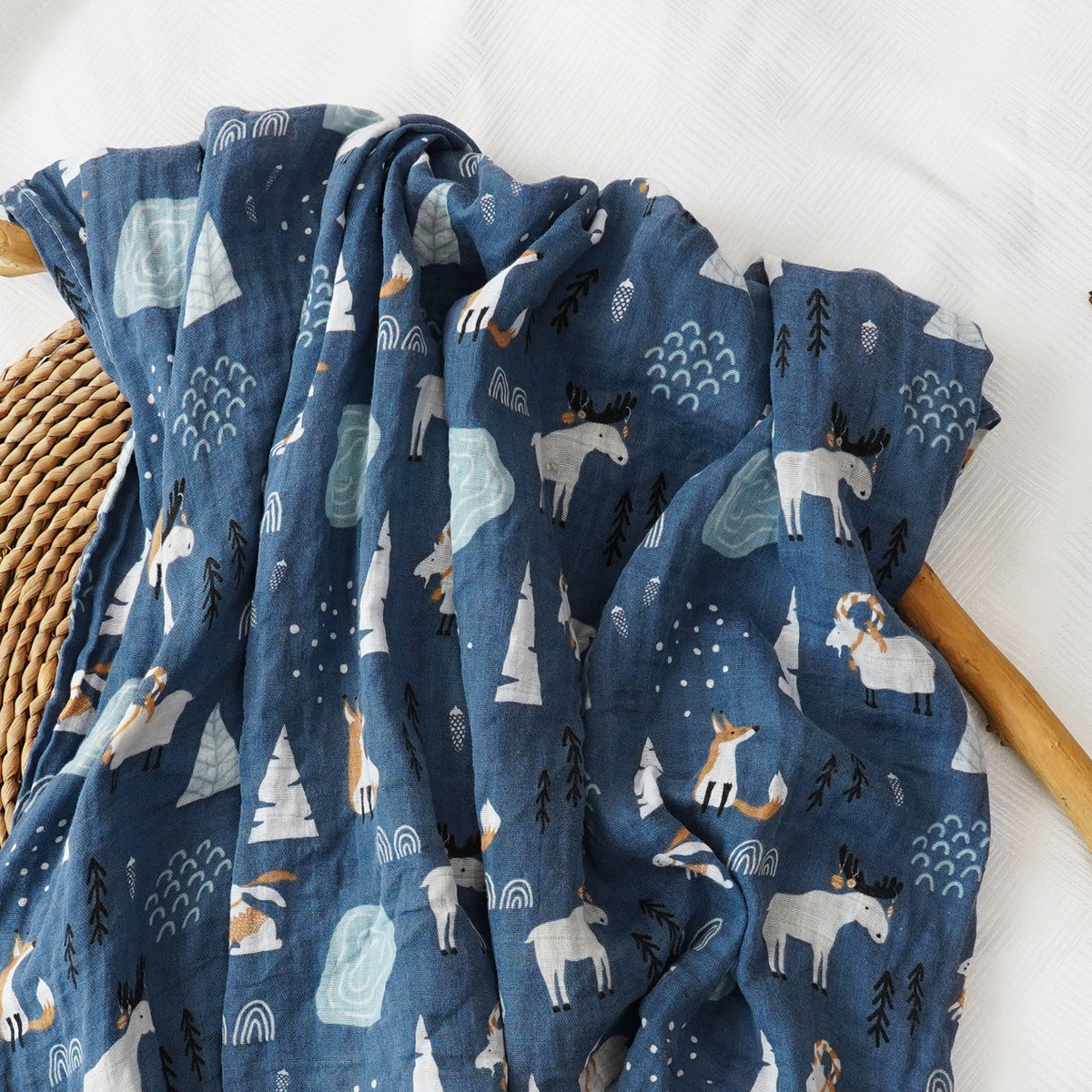 Soft cotton muslin gauze baby blanket shown folded, revealing the light open double layer weave