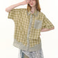 Close up of plaid weave and doll collar on green short sleeve shirt