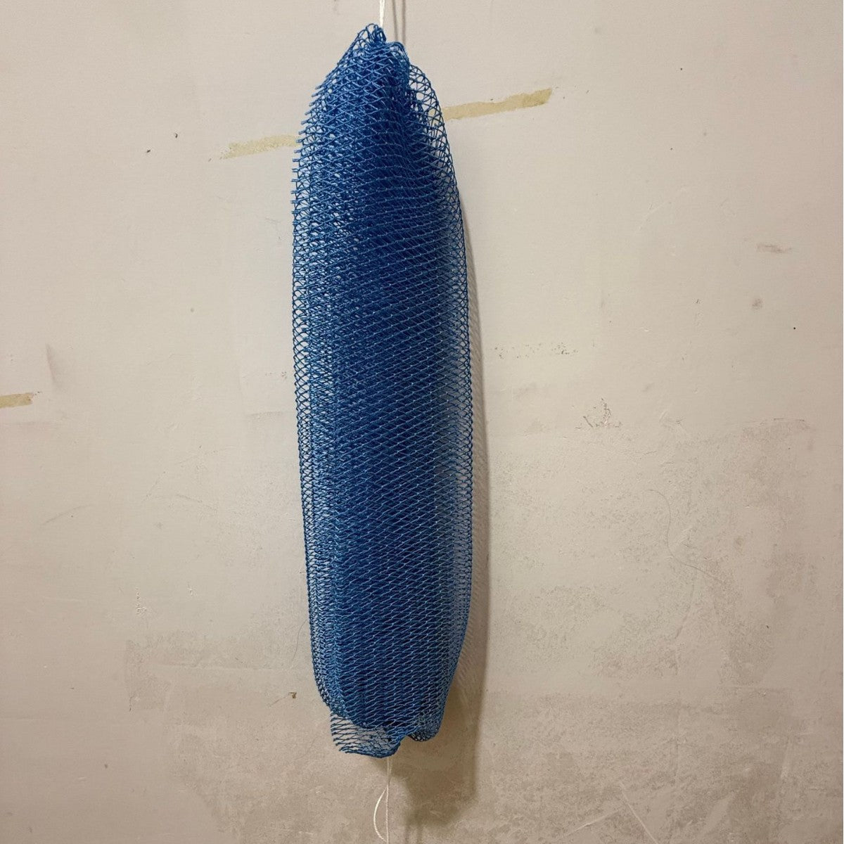 Exfoliating mesh bath strip lathering with body wash in the shower