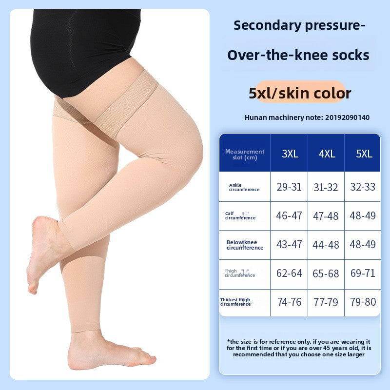 Black closed toe knee high compression sock on the leg against a soft blue backdrop