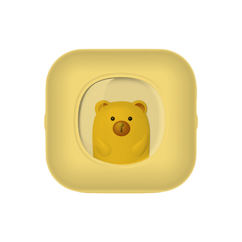 Yellow thermal printer with a golden bear seen through a round window, front view, X7 yellow option