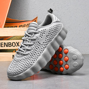 Gray running shoe showing the molded perforated upper and flat laces