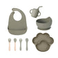 Army green 8-piece baby feeding set with a bib, a sippy cup, a bowl, four utensils and a bear paw plate