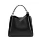 Black cowhide bucket bag front view with rolled handle and center notch