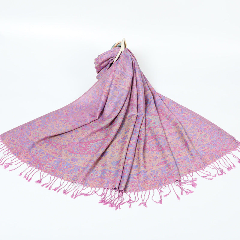 Light purple paisley shawl with a pastel border and pink tassels spread on a white background