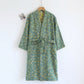 Emerald green cotton gauze kimono robe laid out showing the wrap front and nine tenths sleeves