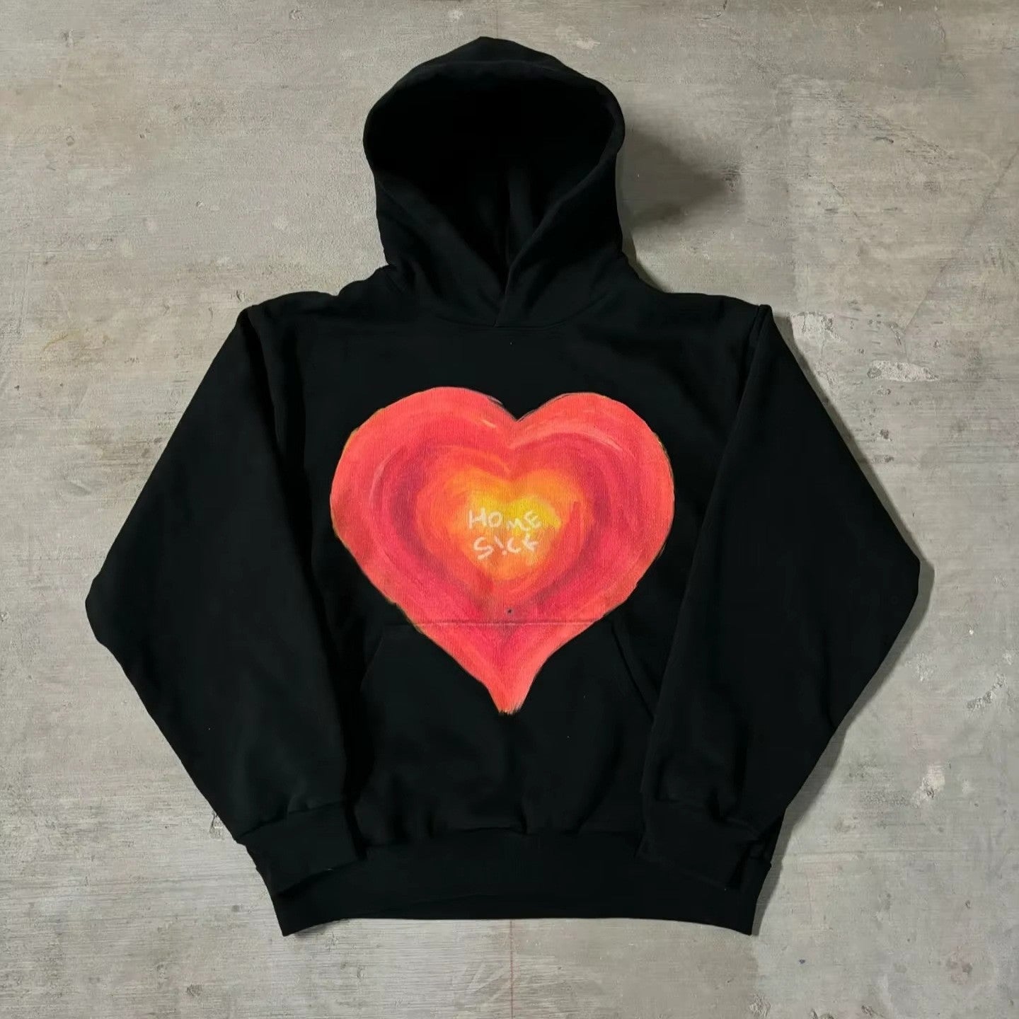 White pullover hoodie with a double portrait print, full hood and ribbed cuffs shown flat
