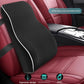 Black memory foam lumbar cushion resting on a red car seat beside the centre console