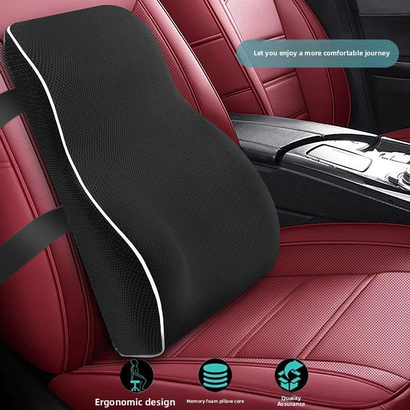 Black memory foam lumbar cushion resting on a red car seat beside the centre console