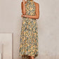 Yellow floral halter neck sleeveless tiered swing maxi dress worn by a model