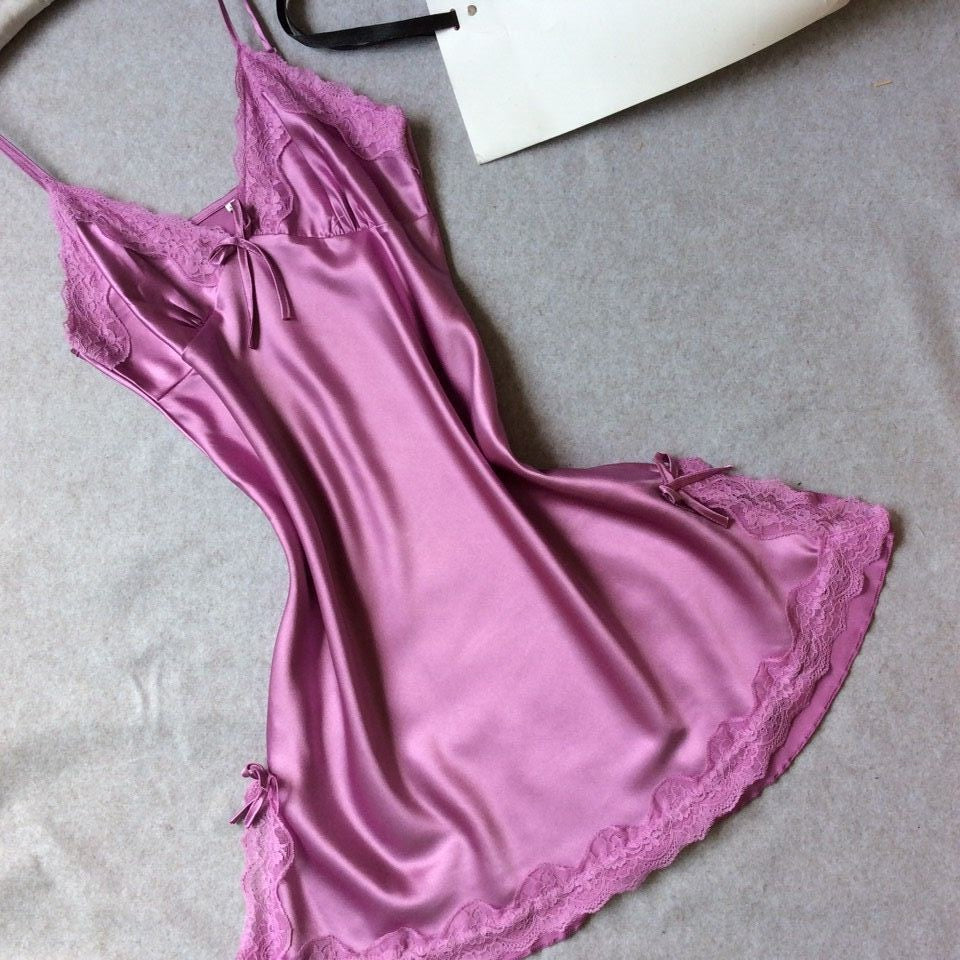 Light purple satin slip nightdress with lace at the neckline and hem, flat on a gray cloth, option photo for size L