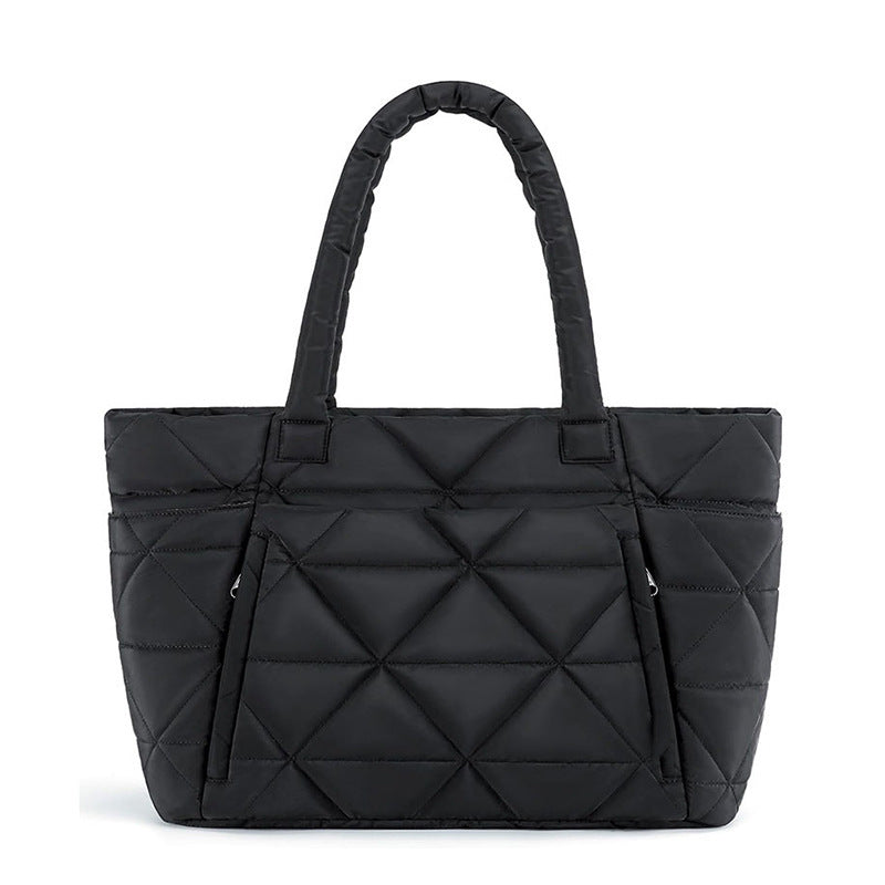 Light blue quilted nylon shoulder bag with rounded handles and front zip pocket
