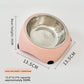 Yellow tilted stainless steel cat feeding bowl on a kitchen floor