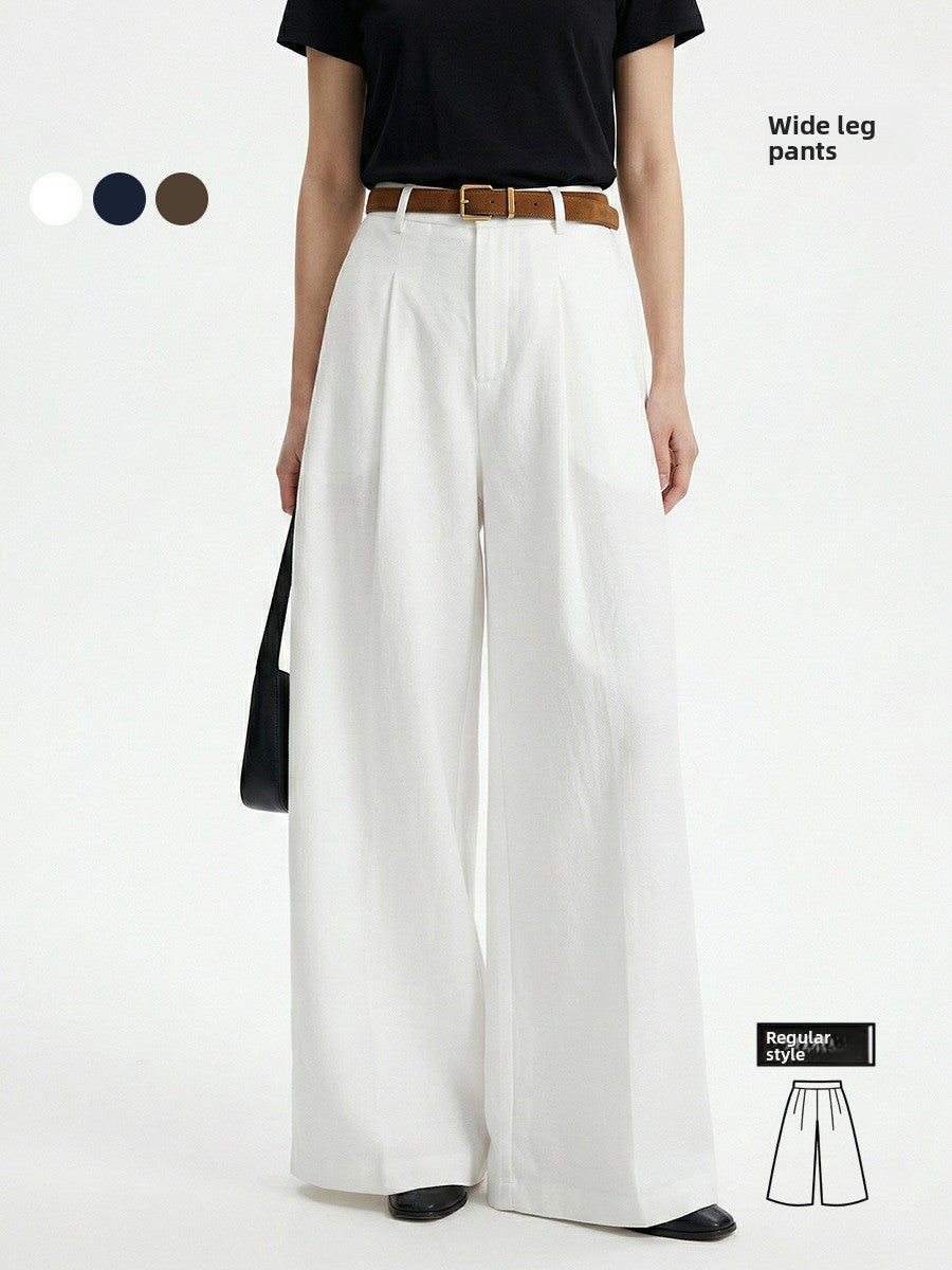 High waisted Tencel cotton wide leg trousers shown full length on a model with a tan belt, front view