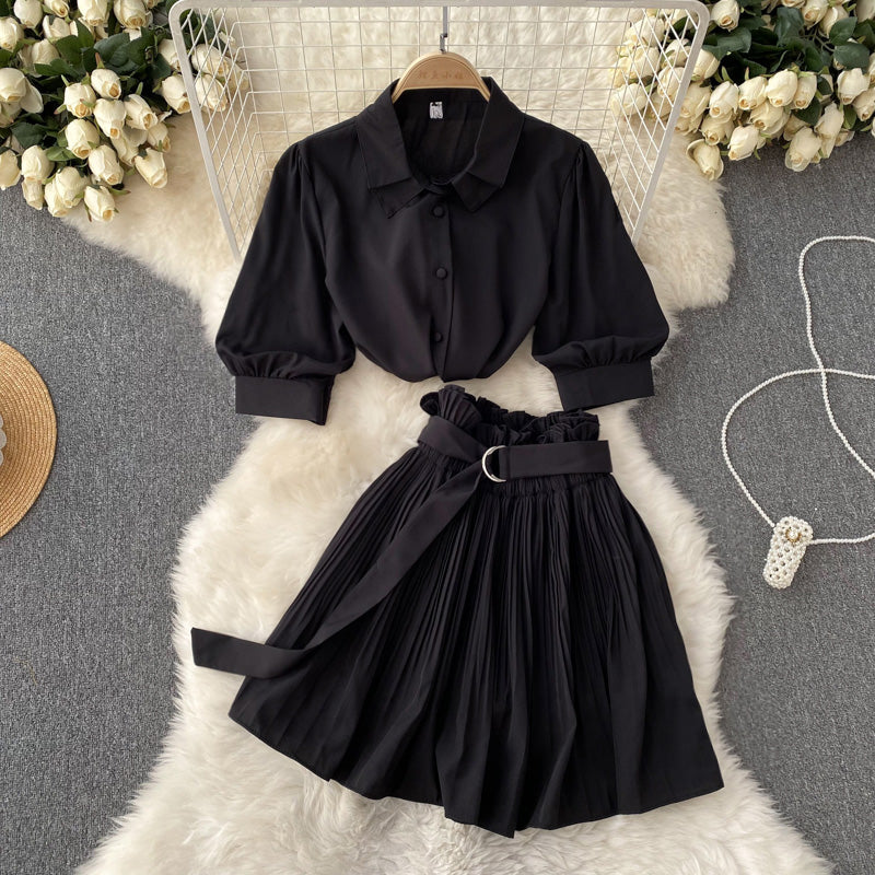The two-piece shirt and skirt set folded and presented neatly