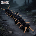 Black cat wearing a segmented centipede Halloween costume with pointed tan legs along its back