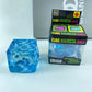Set of blue gel snowflake cube squishy toys in several sizes on a plain background