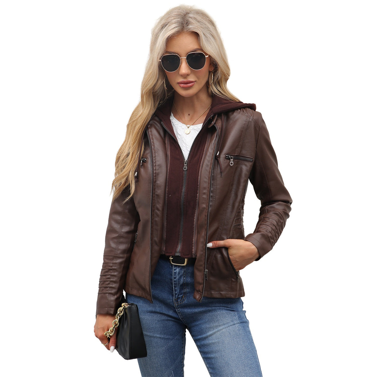 Woman wearing a coffee brown PU leather jacket with a detachable hood over a white top and jeans