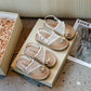Girls' pearl sandals side profile showing the open back and low summer cut