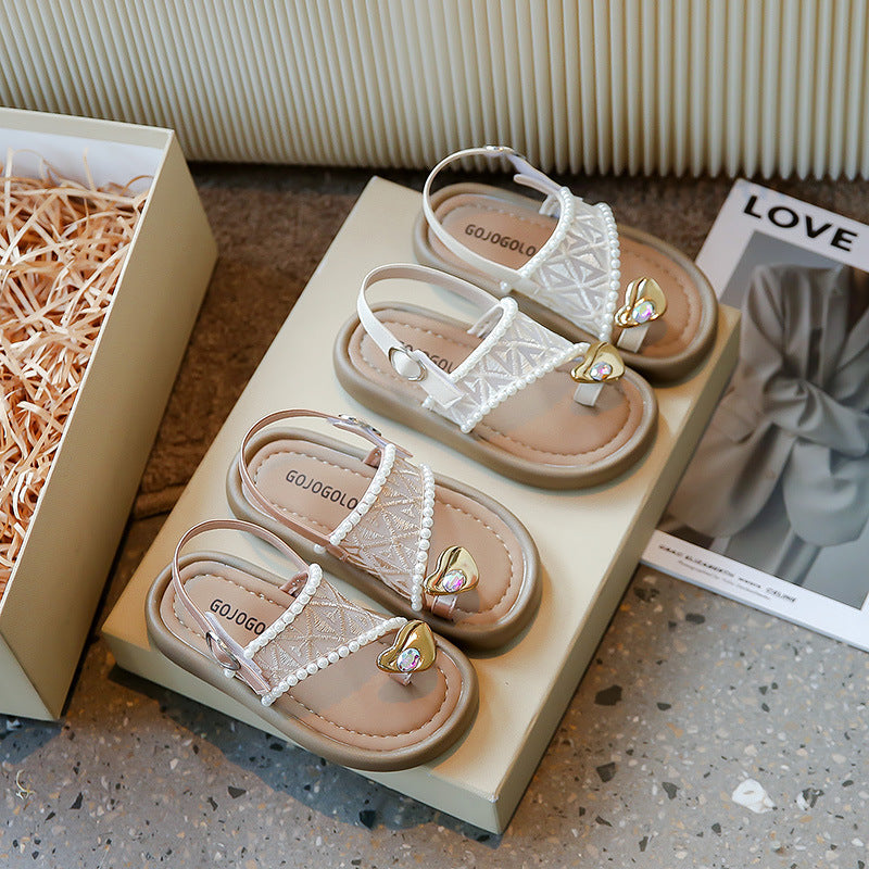 Girls' pearl sandals side profile showing the open back and low summer cut