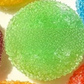 Single round textured squeeze ball held up to show its crinkled crystal skin