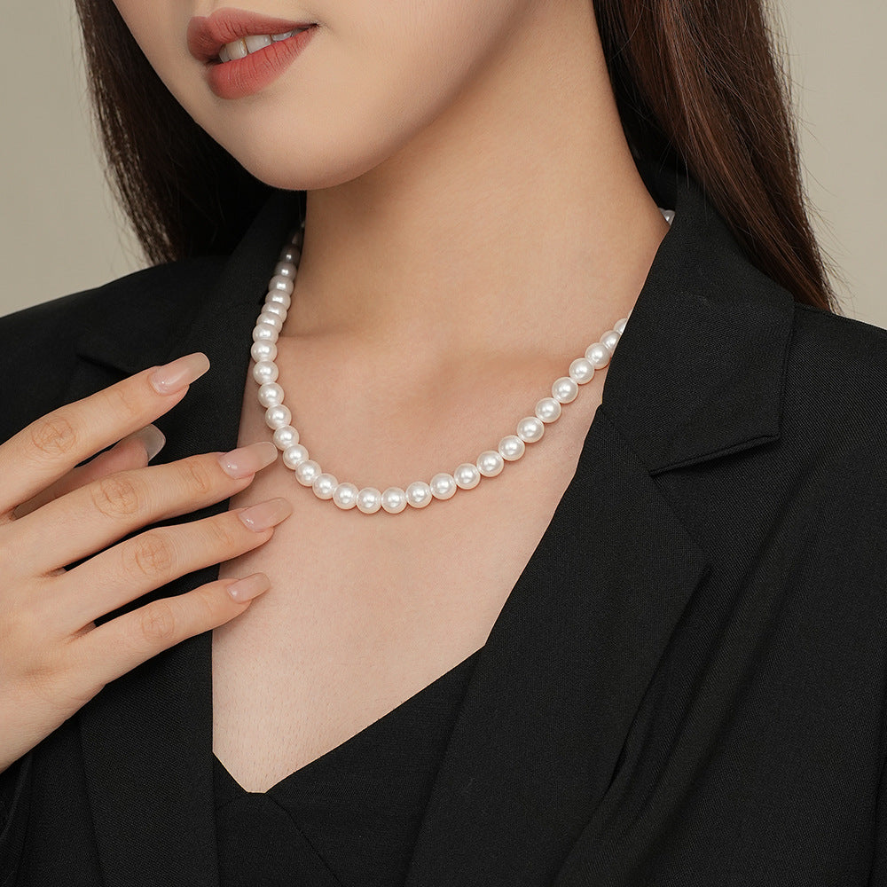 S925 silver round bead necklace at an angle, single polished sphere catching the light