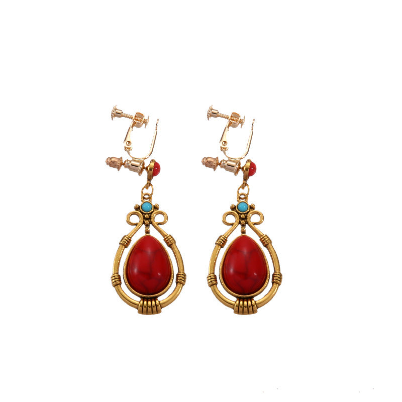 Bohemian tassel and bead clip-on drop earrings, aged tone zinc alloy frame, handmade pair on plain white background