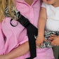 Side profile of the one-shoulder baby sling showing the cross-body strap line