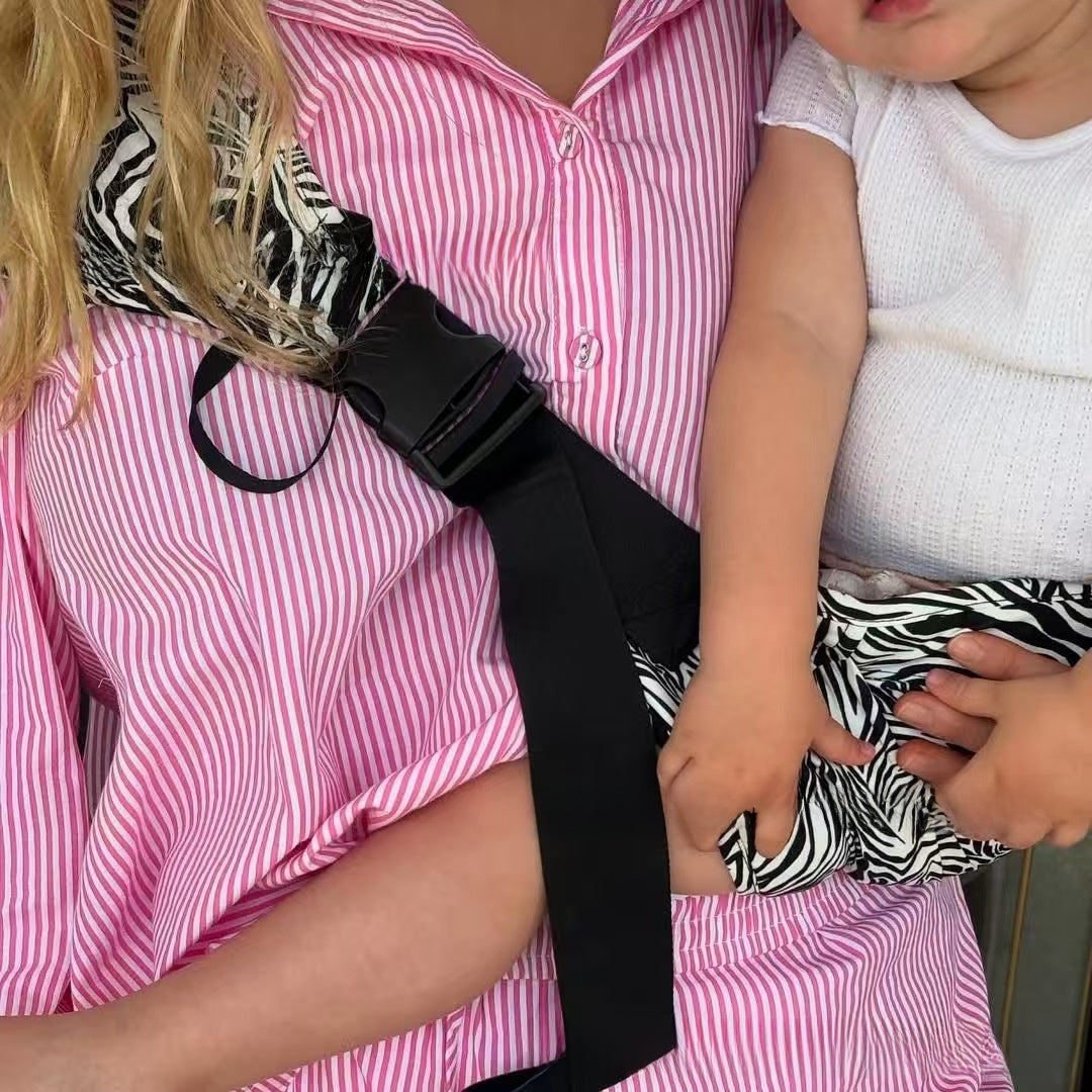 Side profile of the one-shoulder baby sling showing the cross-body strap line