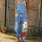 Light blue denim print bib overalls with large flowers down one leg, option photo for size 3XL