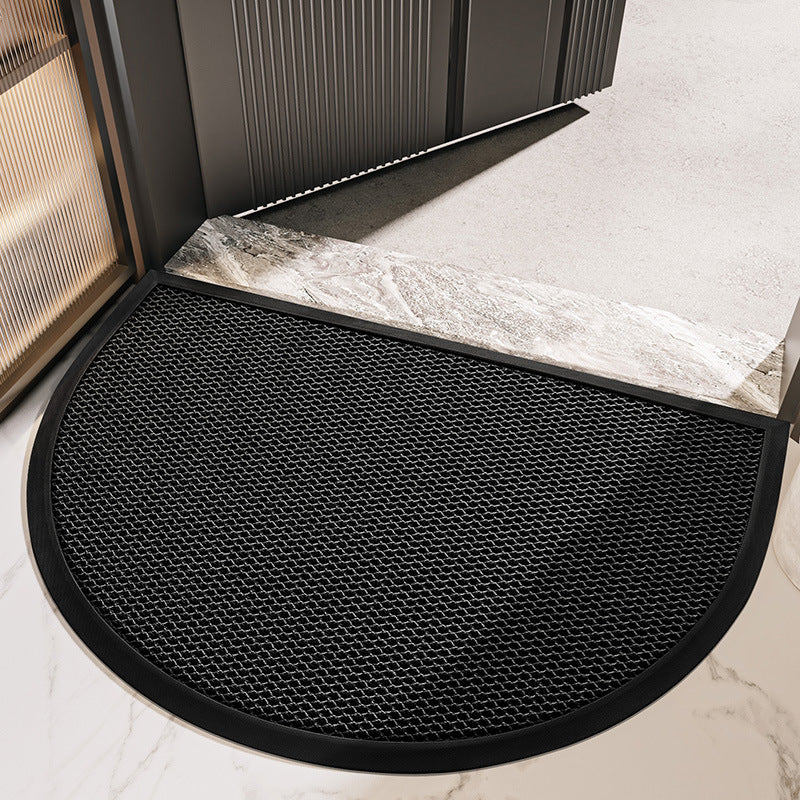 Black semi circular mesh net door mat placed at a sliding door threshold