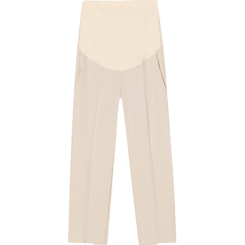 Apricot maternity cropped trousers laid flat showing the elastic top belly panel and leg