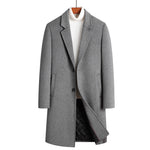 Gray single-breasted long coat with notch lapel on a hanger over a white turtleneck, front view