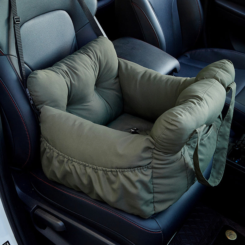 Padded car seat pet bed with raised bolster walls, carry handles and an inner clip empty on a car seat showing the raised b