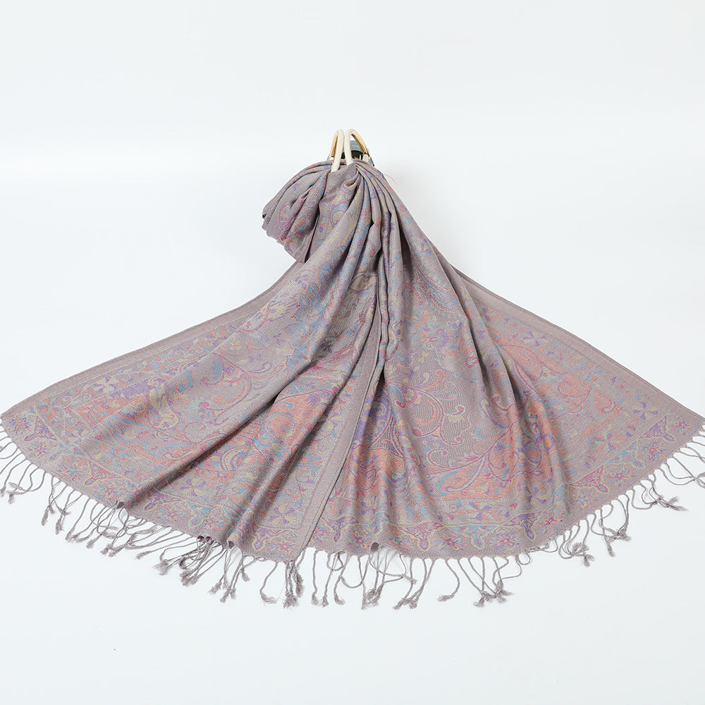Gray paisley jacquard scarf spread on a white background with twisted gray tassel fringe