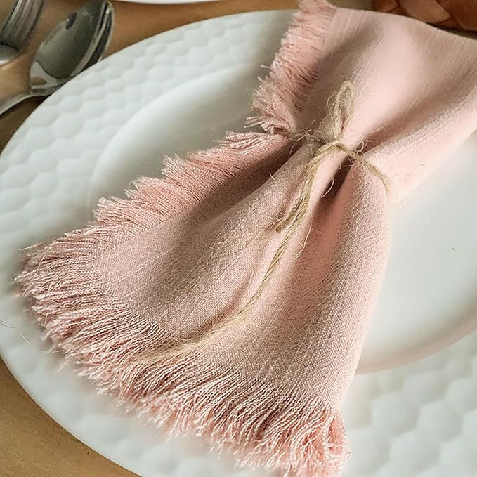 Reverse view of a folded raw edge cotton linen dinner napkin