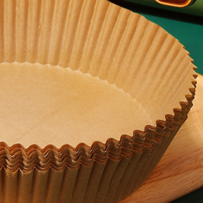 Wood pulp air fryer paper liner with pleated sides shown ready for cooking