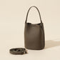 Genuine leather bucket bag in soft studio lighting on a plain backdrop