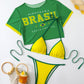 Green and yellow Brasil print three piece bikini set laid flat with mesh tee, triangle top and bottom