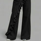 Black wide leg denim trousers with a cascading diagonal ruffle running down the front leg