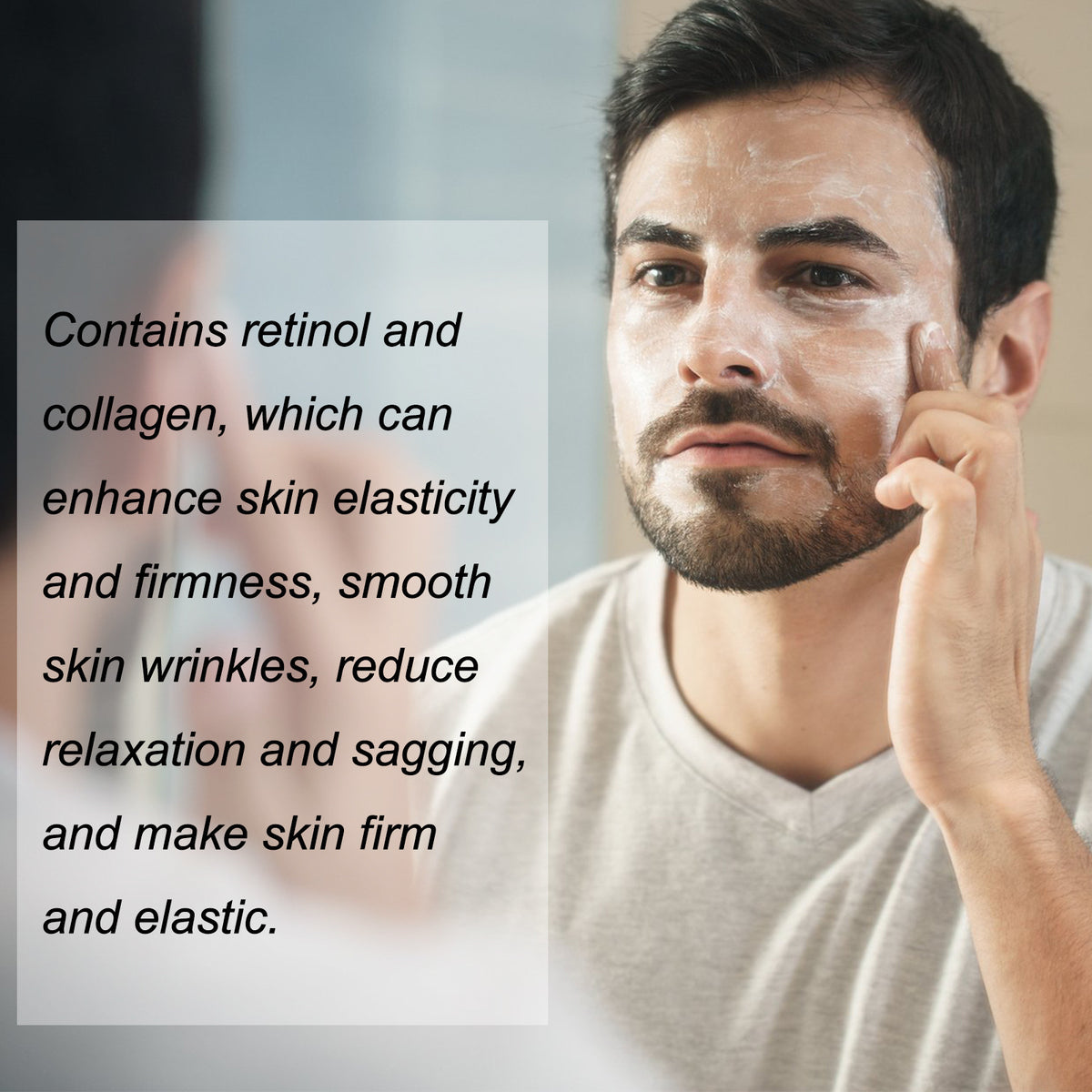 Man smoothing face cream onto his cheek in front of a bathroom mirror