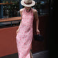 Cherry print pink gingham maxi dress worn walking past a glass facade