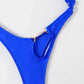 Blue swimsuit shown from the back to reveal the open back between the crossing straps