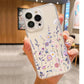 Clear phone case with a purple wildflower design held in a hand