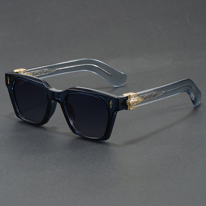 Glossy black square sunglasses with wide temples and a gold arrowhead at the hinge