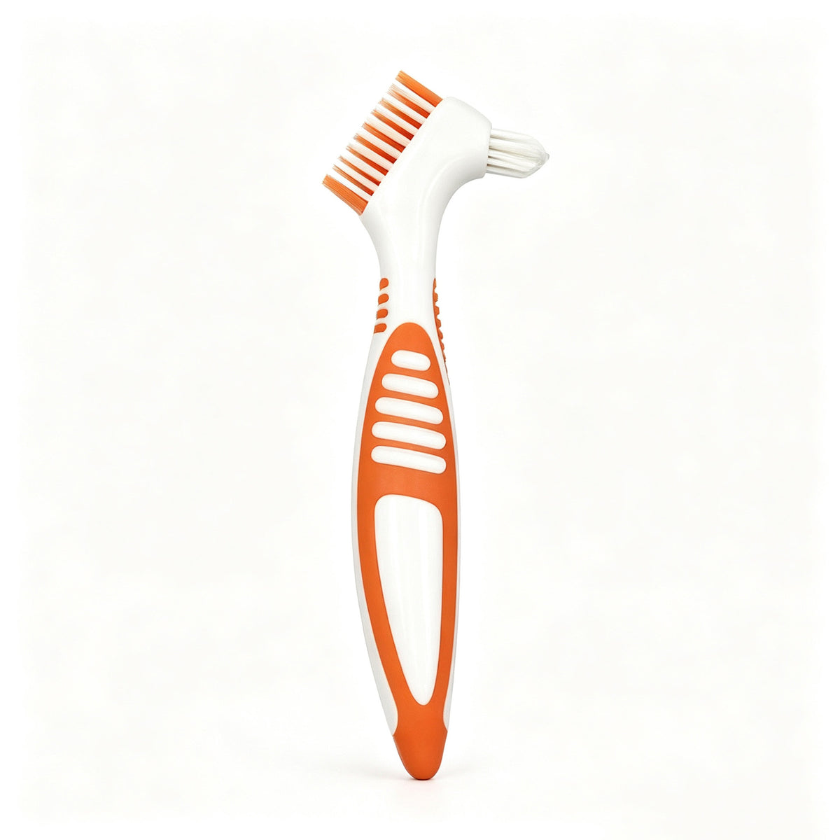 Orange double headed denture brush with a wide flat brush head and a small tapered head on a white handle
