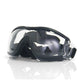 Dog wearing black frame goggles with a mirrored lens in a park