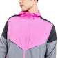 Close view of the zip front and colour block panels of a hooded sports jacket